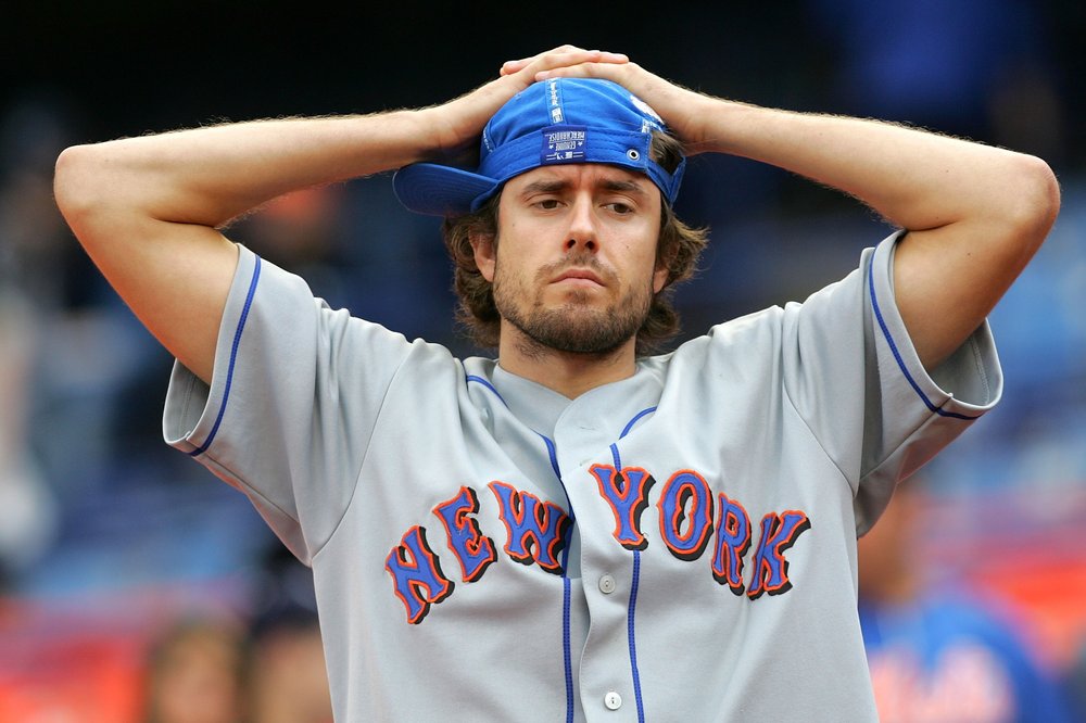 A man in a Mets jersey looks dejected.