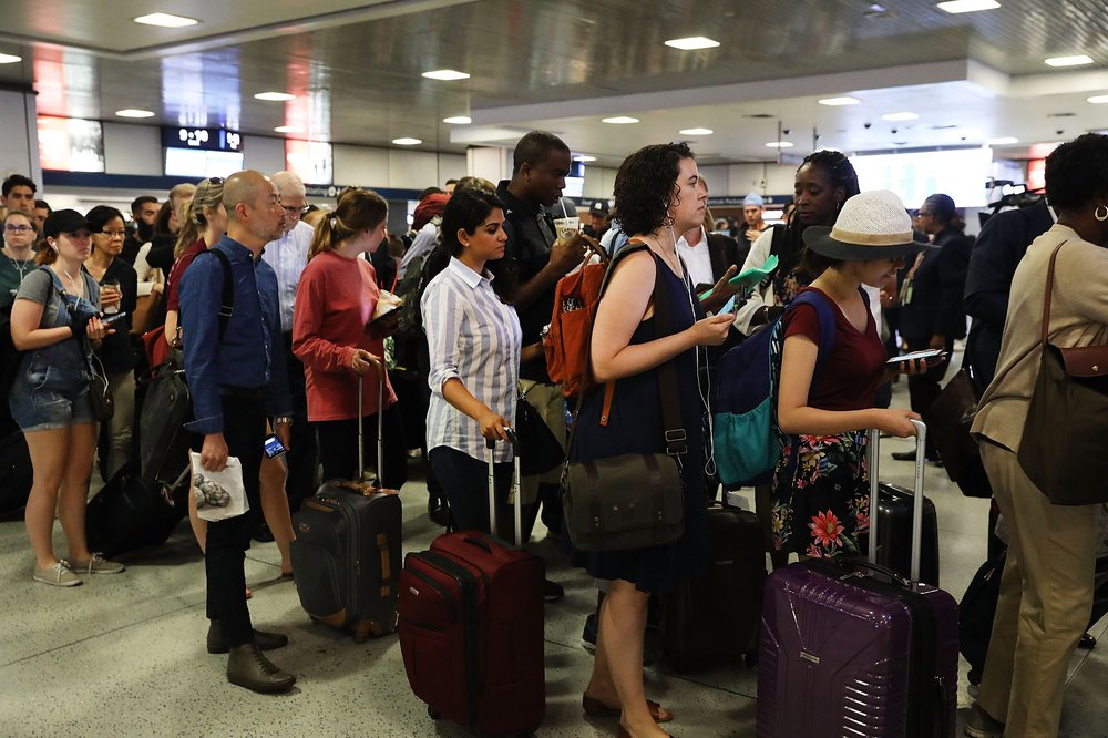 Commuters wait for a train at Pennsylvania Station.