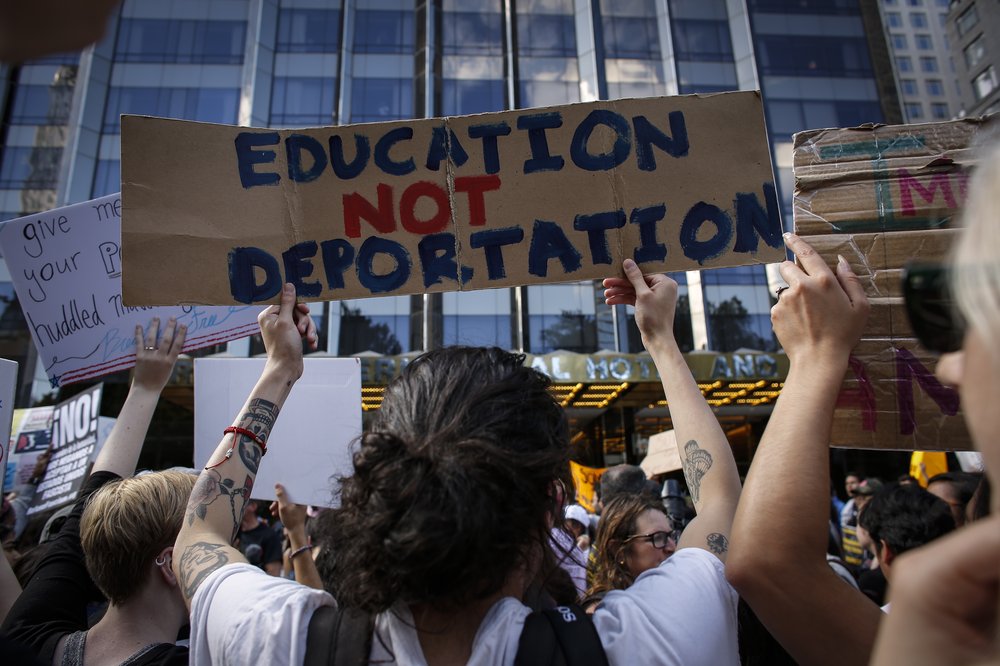 A woman holds a placard at a protest in New York City in September, 2017, following then President Donald Trump's decision to end a program sparing some certain young immigrants from deportation.