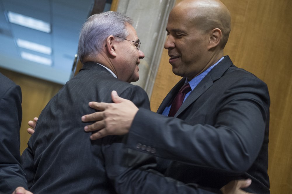 Sen. Bob Menendez, at left, greets Sen. Cory Booker, during a Senate Foreign Relations Committee meeting on October 5, 2017.