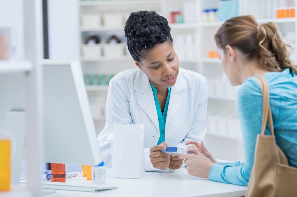 A pharmacist discusses a medication with a customer. Starting after rules are finalized in 2024, New Jersey will make birth control available to women without prescriptions.