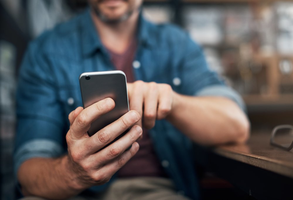 Closeup shot of an unrecognizable person using a mobile phone.
