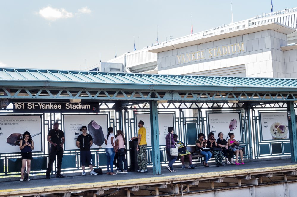 Bronx subway riders standing at the elevated Yankee Stadium station platform. They're frustrated.