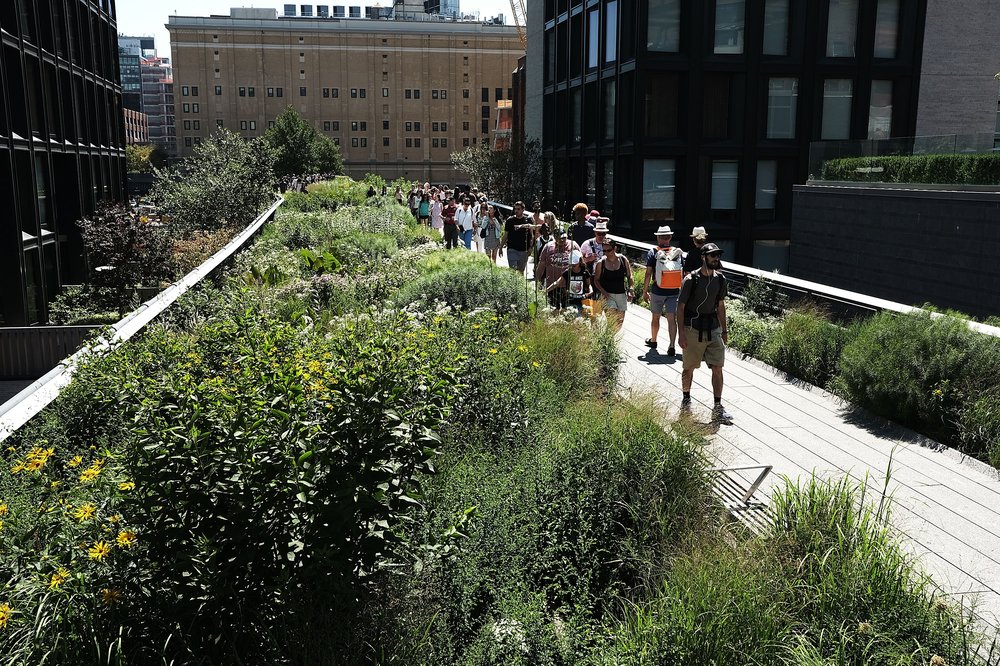 People walk along the High Line in Manhattan on July 9, 2018.