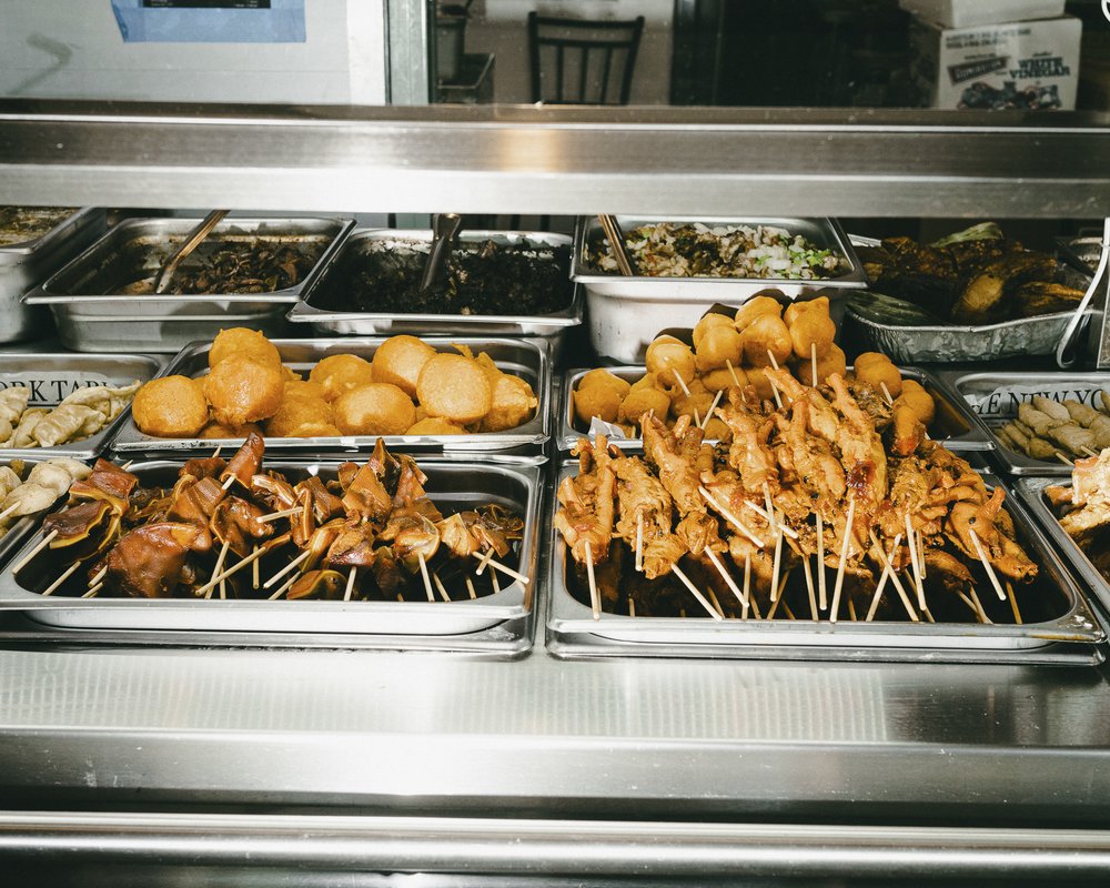 A serving counter filled with different fried treats.