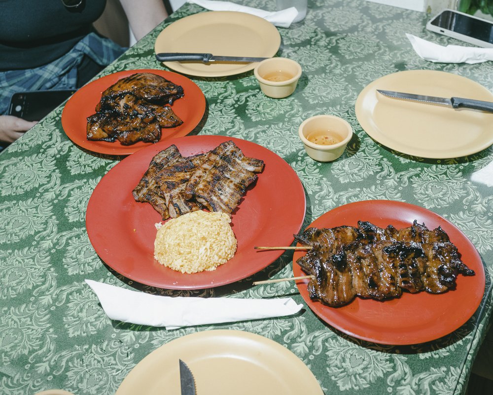 Three plates of food featuring meat skewers, and rice dishes.