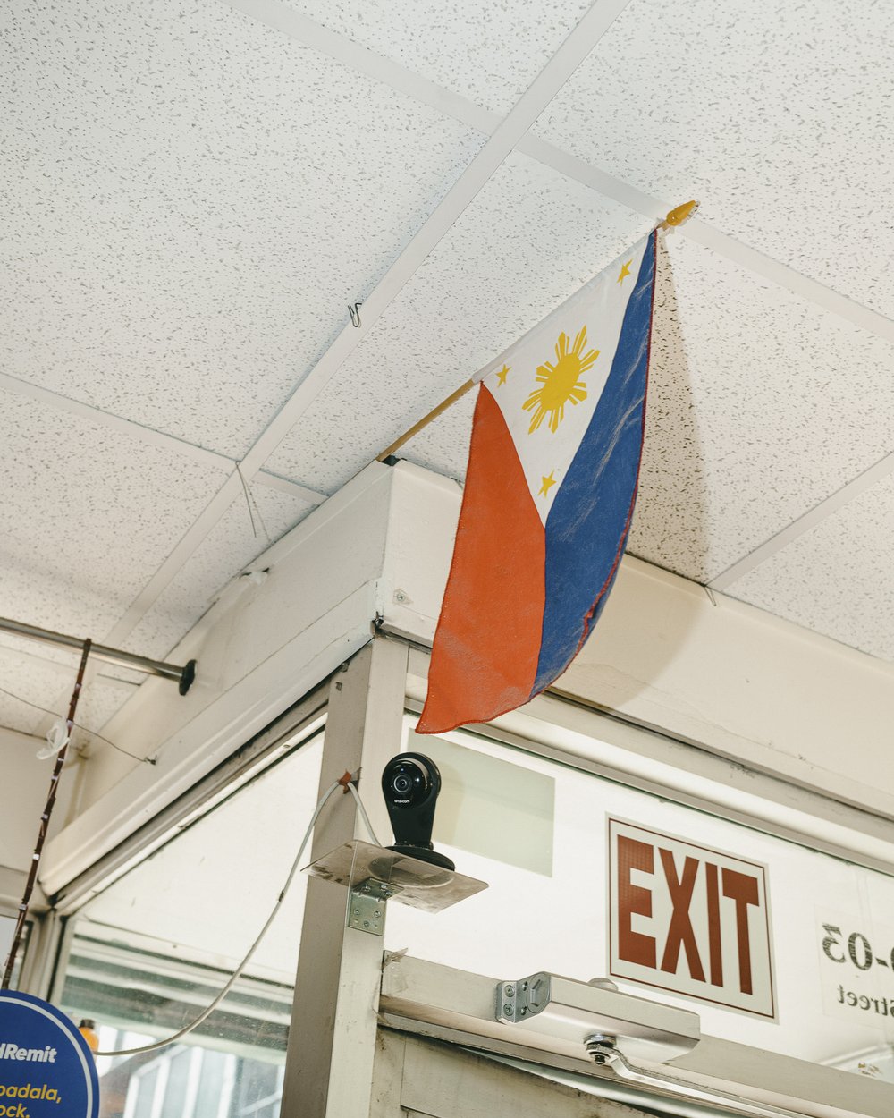 A Filipino flag hangs from the ceiling of a convenience store.