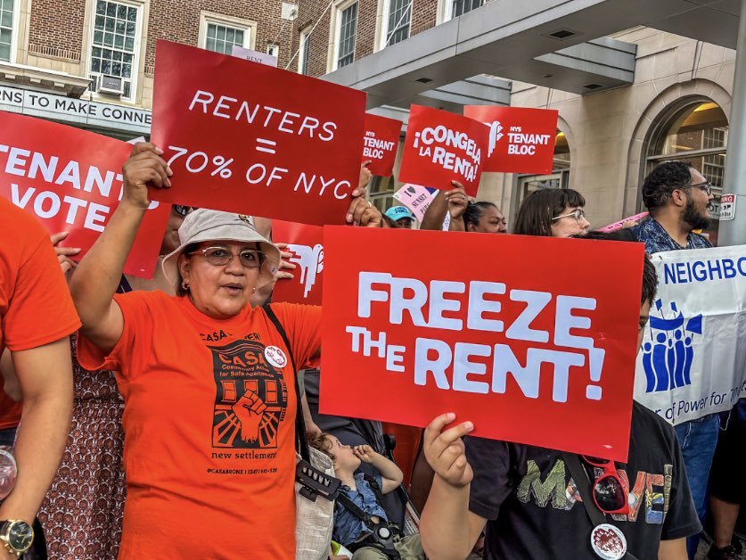 Tenants hold signs demanding a rent freeze outside the Rent Guidelines Board hearing in Manhattan.