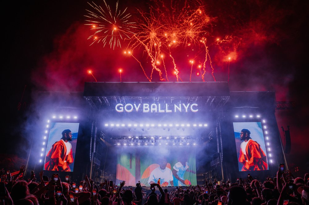 A stage with a performer and flames in the background.