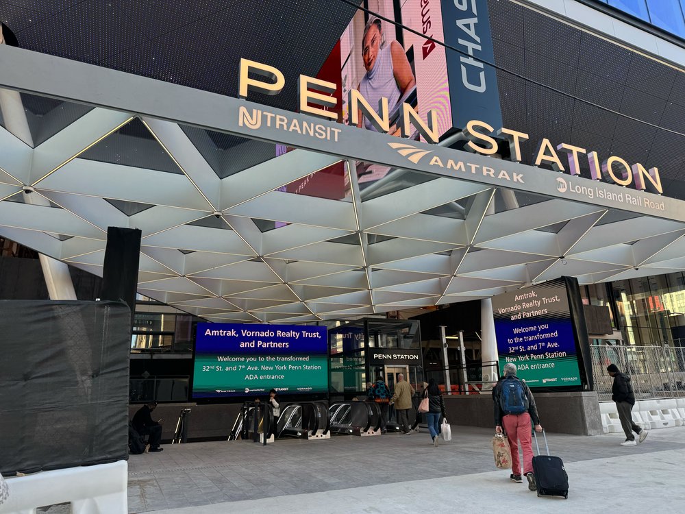 Penn Station's new entrance includes new signage and a glass canopy is replacing the previous concrete overhang — dating back to 1967.