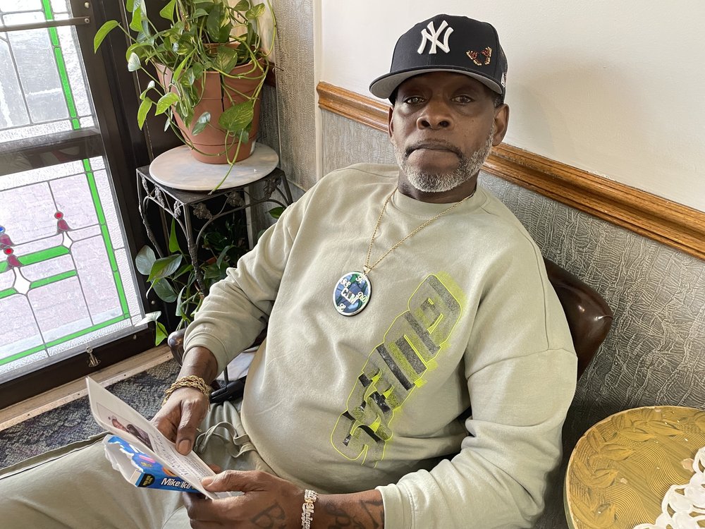 Kerry Moore holds the booklet for his brother Terrence Moore's funeral in Brooklyn on March 25, 2025.