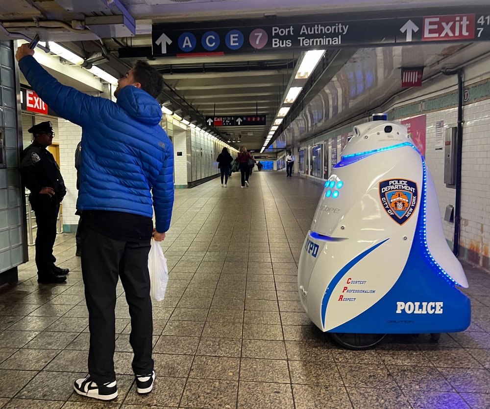 A man takes a selfie with a police robot in Times Square this week.