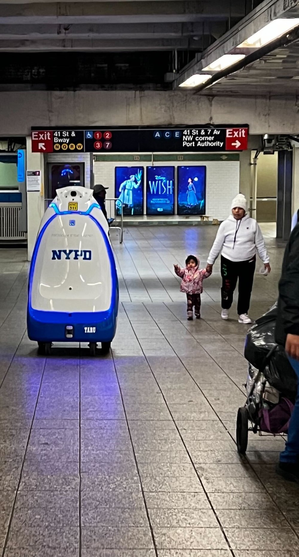 The NYPD robot patrols the Times Square subway station.