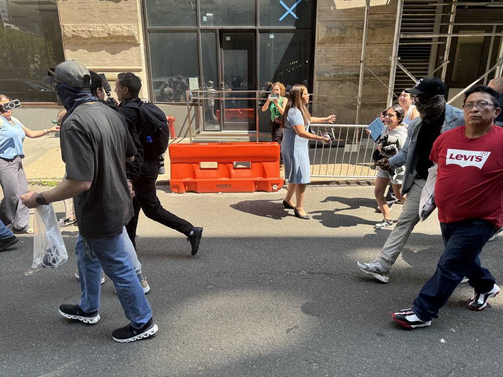 Plainclothes immigration enforcement officers in mask seen taking a man into detention following a required check-in with immigration authorities in Manhattan on Wednesday.