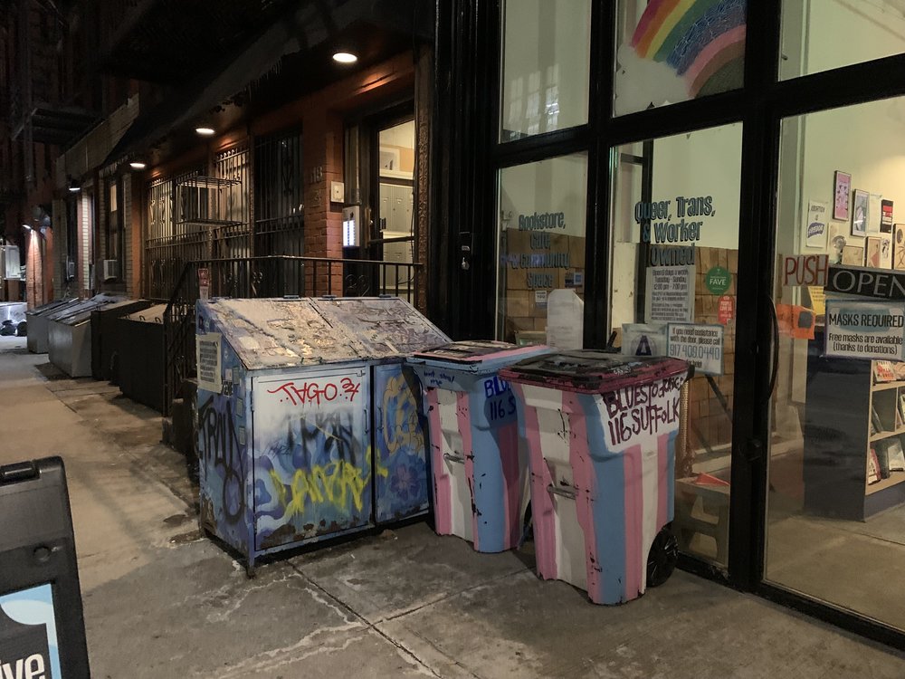 Trash cans in front of a bookstore