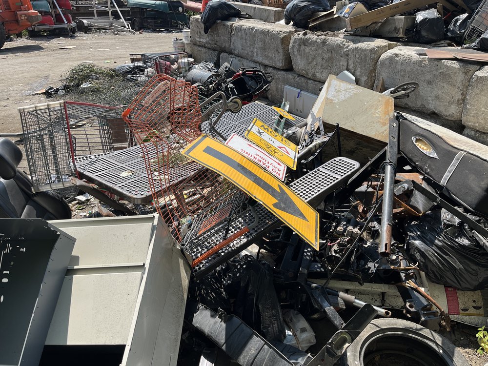A pile of metal signs and mattresses in the Bronx.