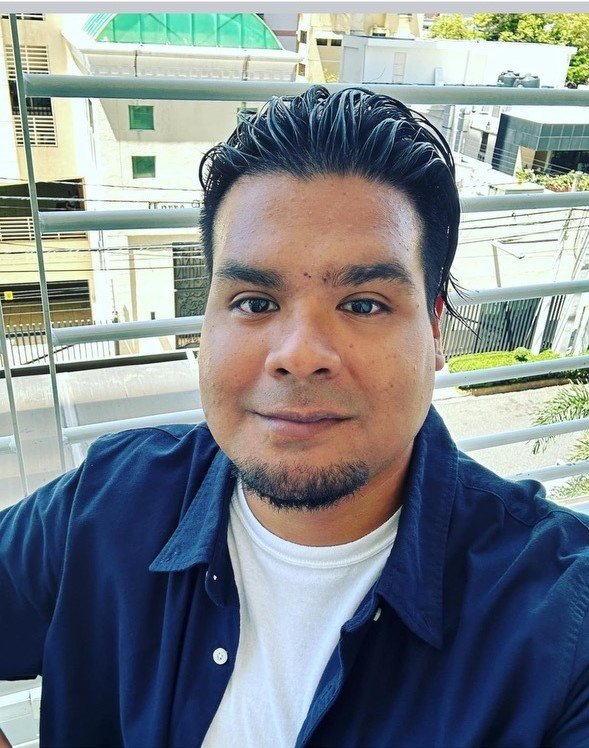 A man smiles in a selfie.