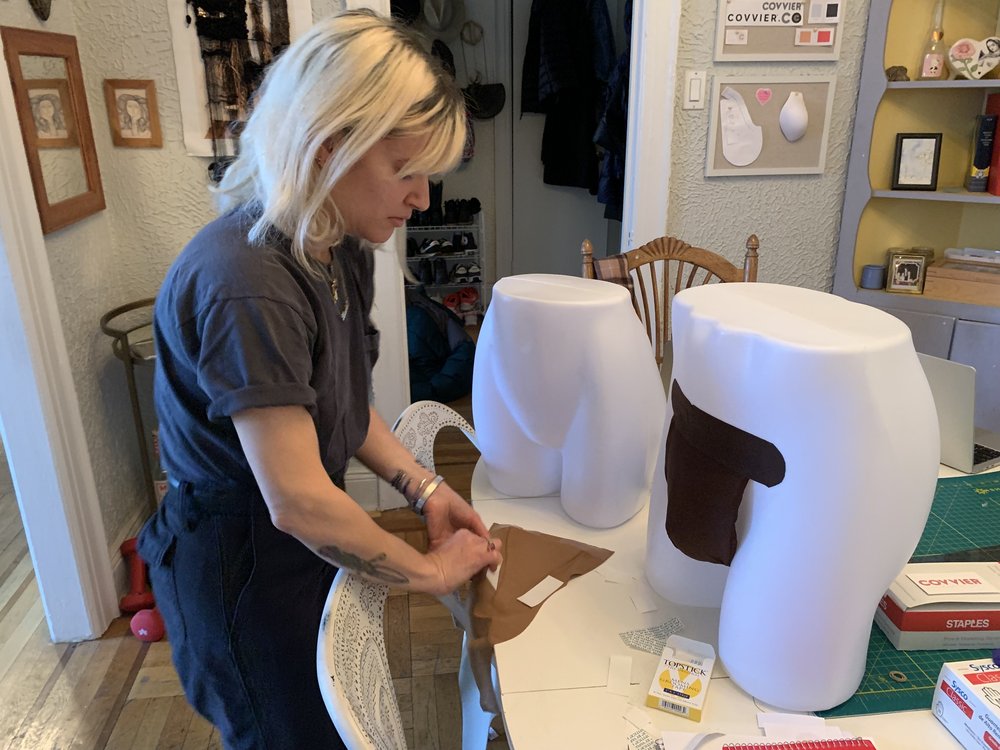 A woman works on modesty garments