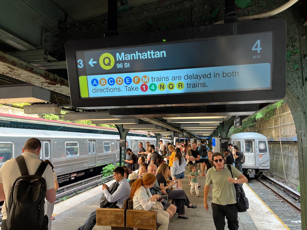 Multiple trains are shown as delayed on a digital screen at the Prospect Park station in Brooklyn on July 31, 2025.