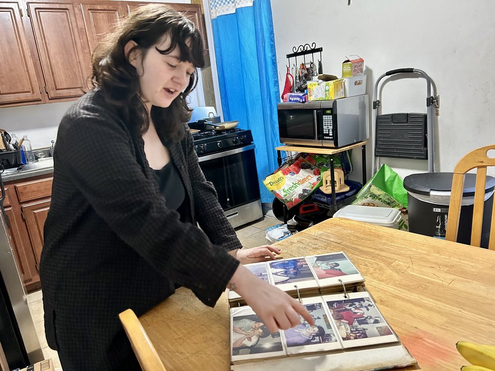 Gabrielle Vines looks through old photo albums in the apartment where her great-grandmother, grandmother and mother used to live.