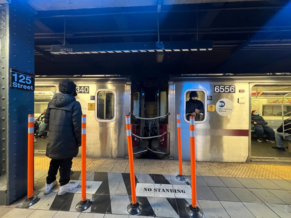 Several riders crossed the rubber poles into the no-standing area to ask conductors questions about train service.