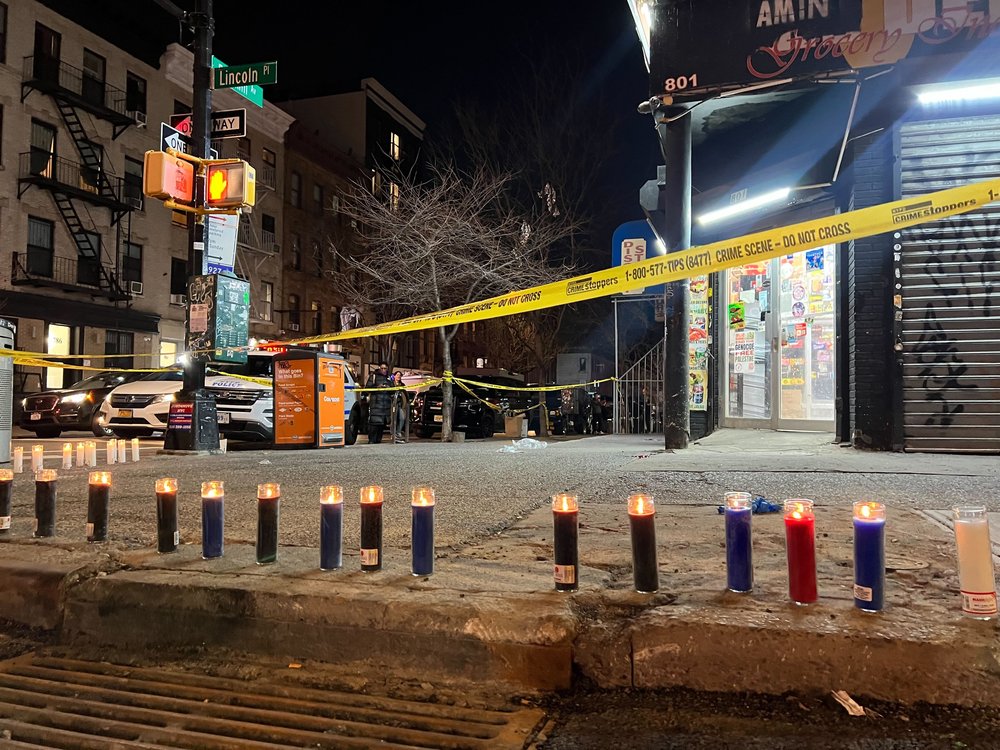 A vigil is arranged at the scene where a man was fatally shot in Brooklyn on Monday.