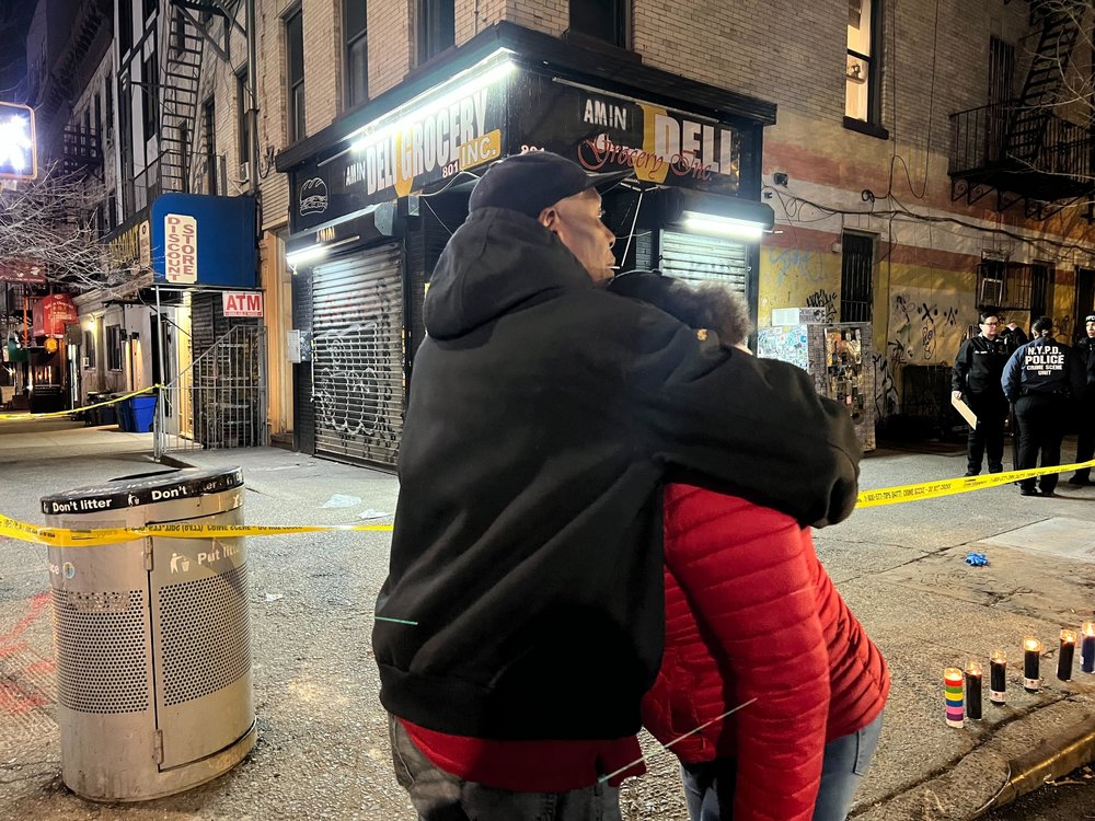 The victim's mother is comforted at the scene of the shooting on Monday night.