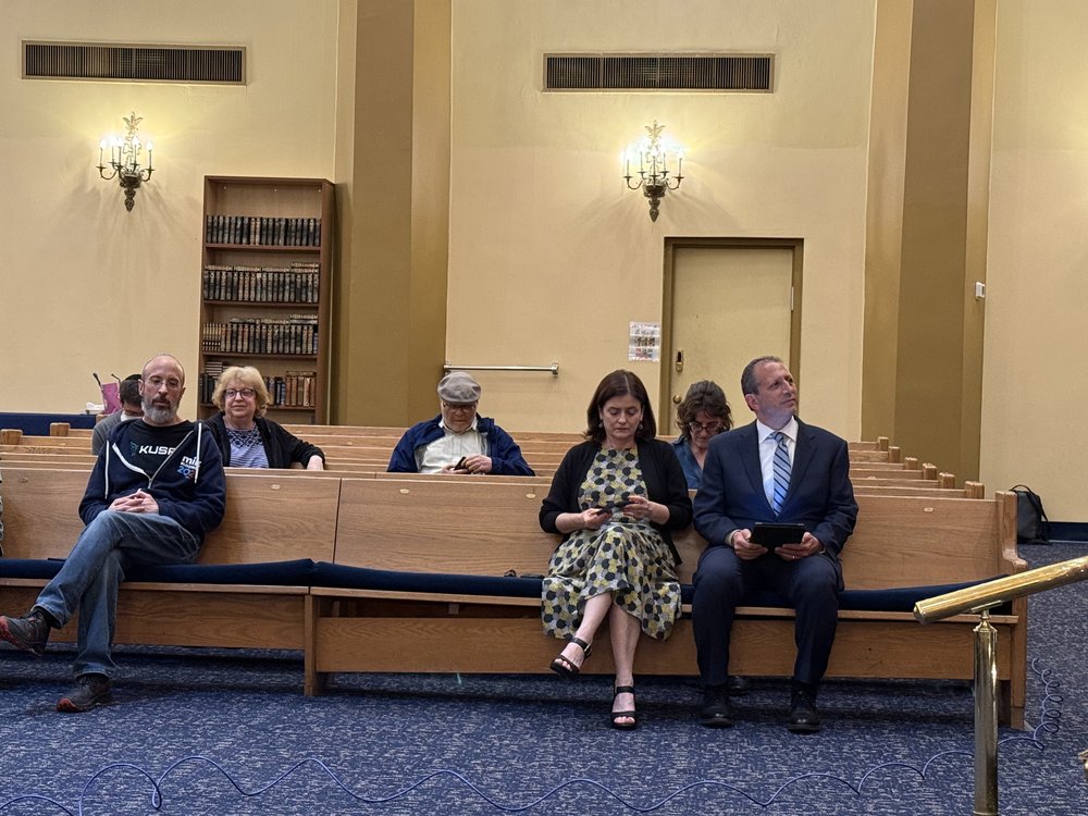 Brad Lander in the pews of a mostly empty synagogue.