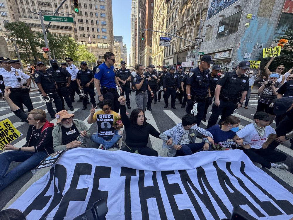 Immigrants' rights advocates blocked traffic outside 26 Federal Plaza in Lower Manhattan on Friday. They decried tactics used by Immigration and Customs Enforcement agents and alleged woeful conditions in temporary holding for immigrants being used by ICE.
