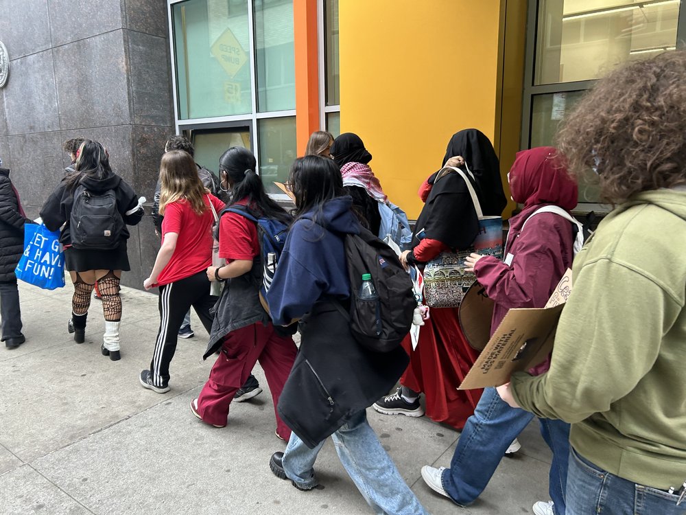 Students walking on the sidewalk.