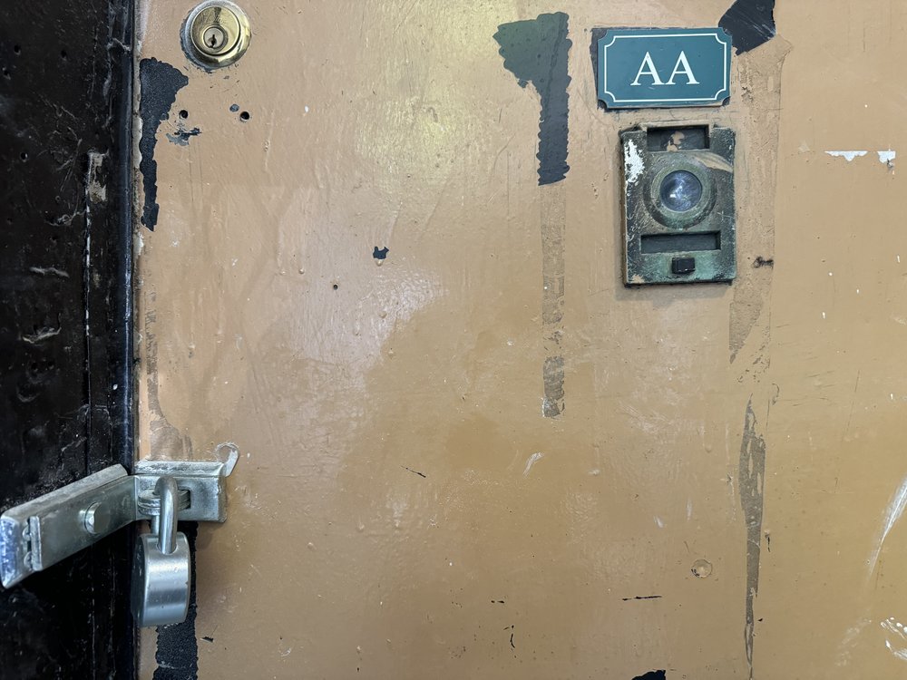 A photo of a padlocked door that was once the entrance of the Divino Niño Day Care Center.