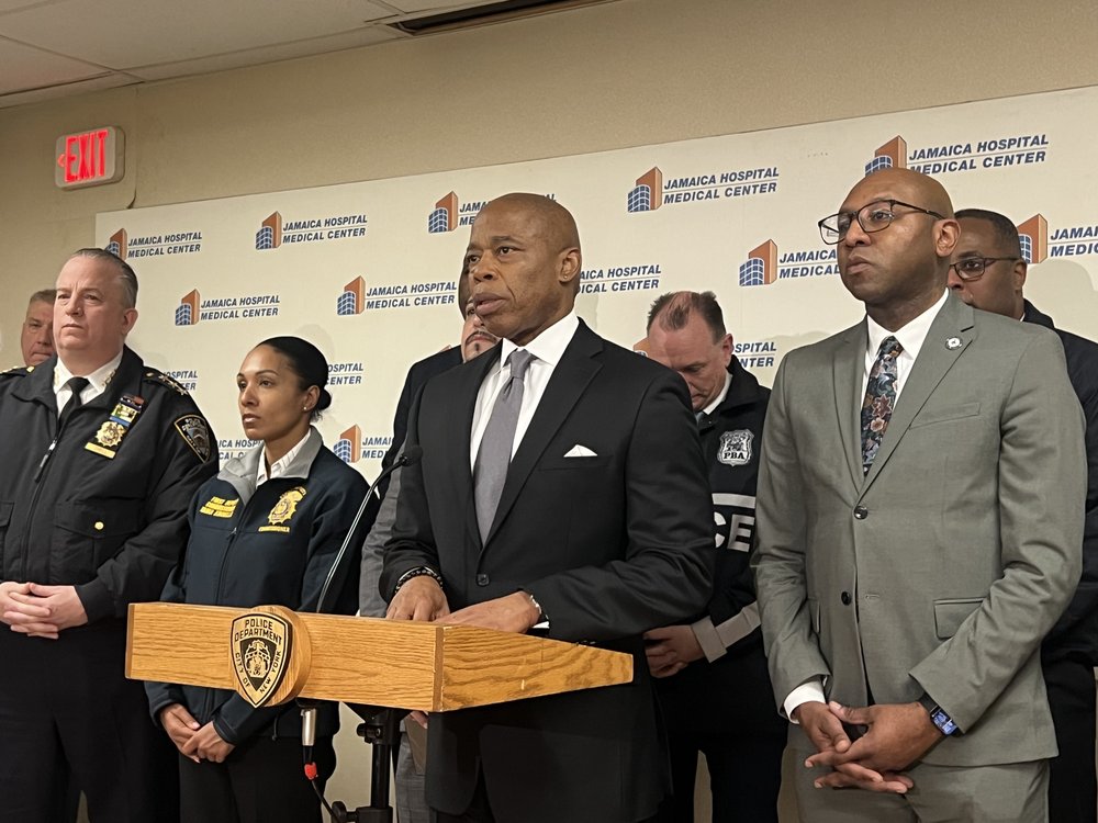 Mayor Eric Adams speaks alongside NYPD brass after an officer was fatally shot in Queens.