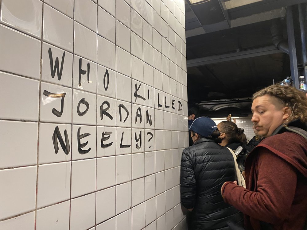 Protesters gather on the subway platform where a man died after being placed in a chokehold by another passenger.