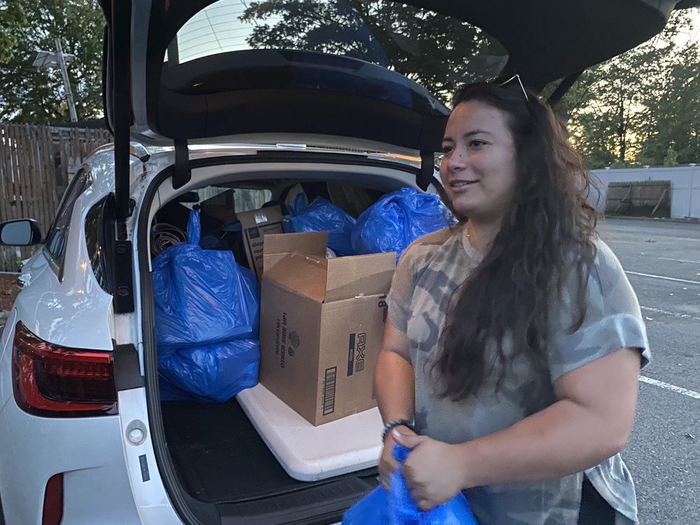 Laura Bustamante, policy and campaign manager with the New Jersey Alliance for Immigrant Justice, sorts through the welcome bags of food, diapers and hygiene products organizers brought to Teterboro Airport, where a plane rumored to be full of migrants from Texas was scheduled to arrive.