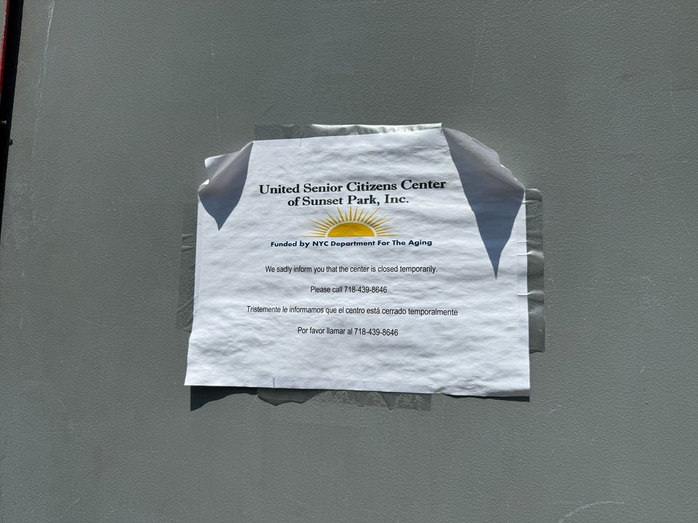 A sign informing visitors to the United Senior Citizens Center of Sunset Park that the facility is currently closed.