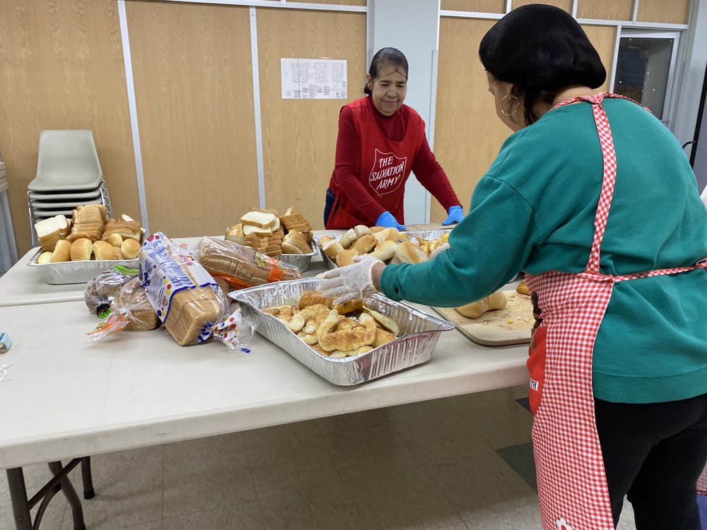 : Volunteers at the Salvation Army Queens Temple Corps prepare a fish soup and bread on Thursday, Oct. 12, in time for an 11 a.m. pick up hot meal service.