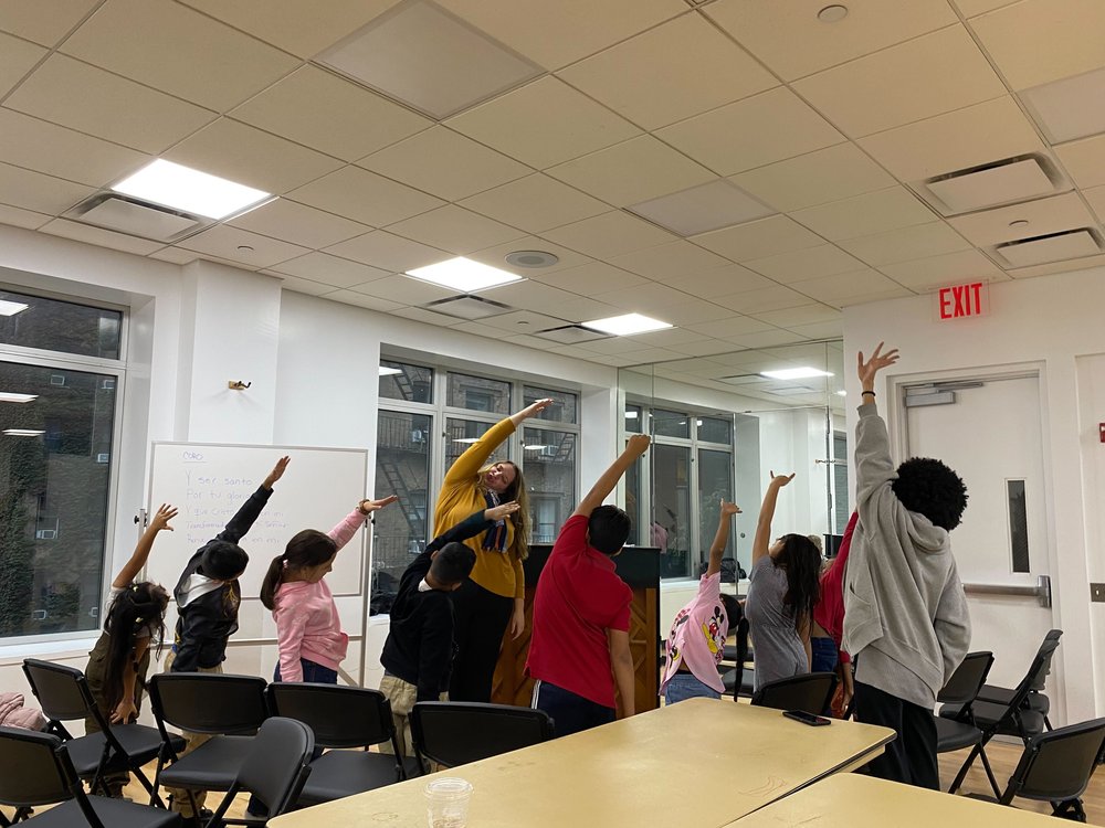 Students stretch out their arms and warm up before music class on Wednesday, Oct. 18 at The Salvation Arm Times Square.