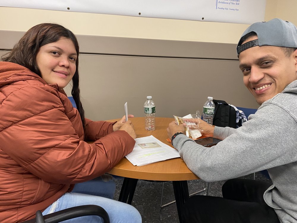 Andreina Gonzalez and Moises Gutierrez wait their turn to apply for temporary protected status at a legal clinic led by Catholic Charities of New York last week.