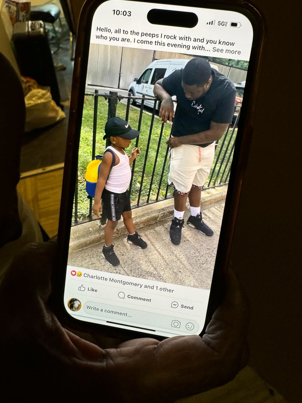 A cell phone showing a picture of a man and child.