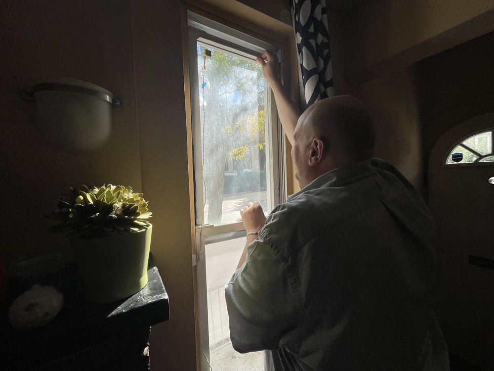 Christopher Jaray peers out his window at Forest Hills Stadium.