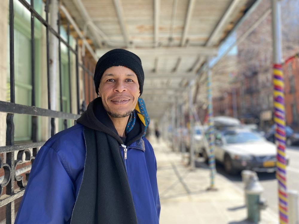 Eduardo Ventura, 37, wears a blue jacket and a black scarf around his neck. He says he's experienced a dozen encampment sweeps.