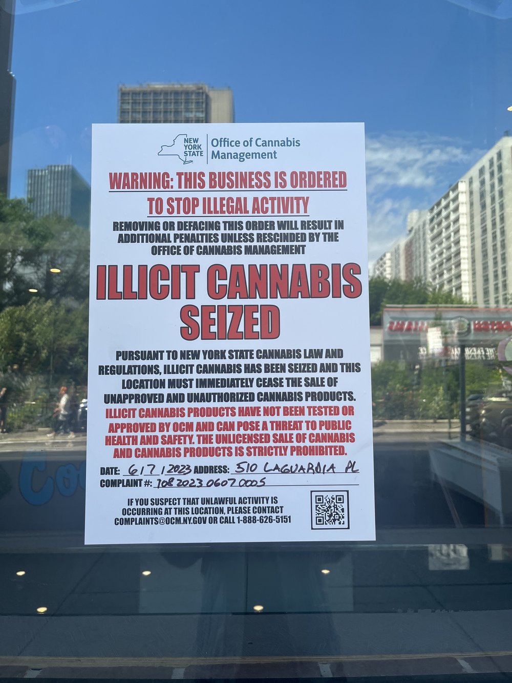A sign on a shop window noting that illegal cannabis was seized.