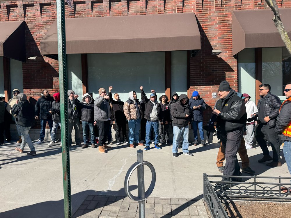 A group of people respond to protesters as they wait to enter Cuomo's endorsement rally.
