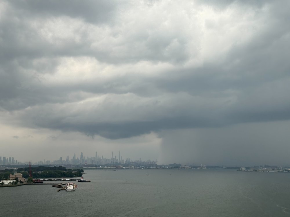 Storm clouds loom over Lower Manhattan as heavy rain moves into New York City Thursday afternoon.