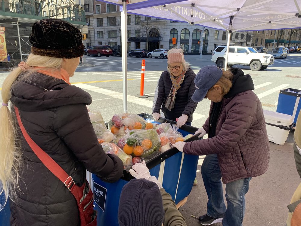 Volunteers at the West Side Campaign Against Hunger distribute bags of fresh produce to New Yorkers on the corder of 86th Street and West End Avenue on March 18, 2025