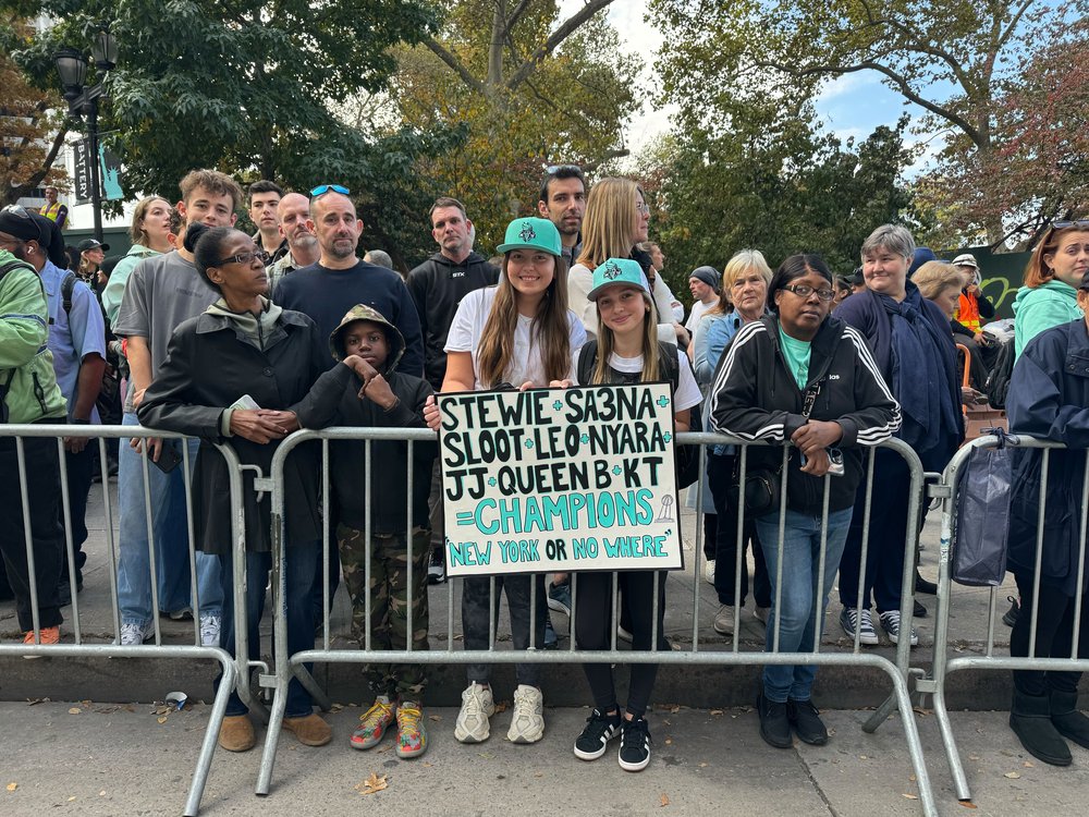 Spectators line up for the ticker-tape parade to honor the Liberty along NYC's "Canyon of Heroes."