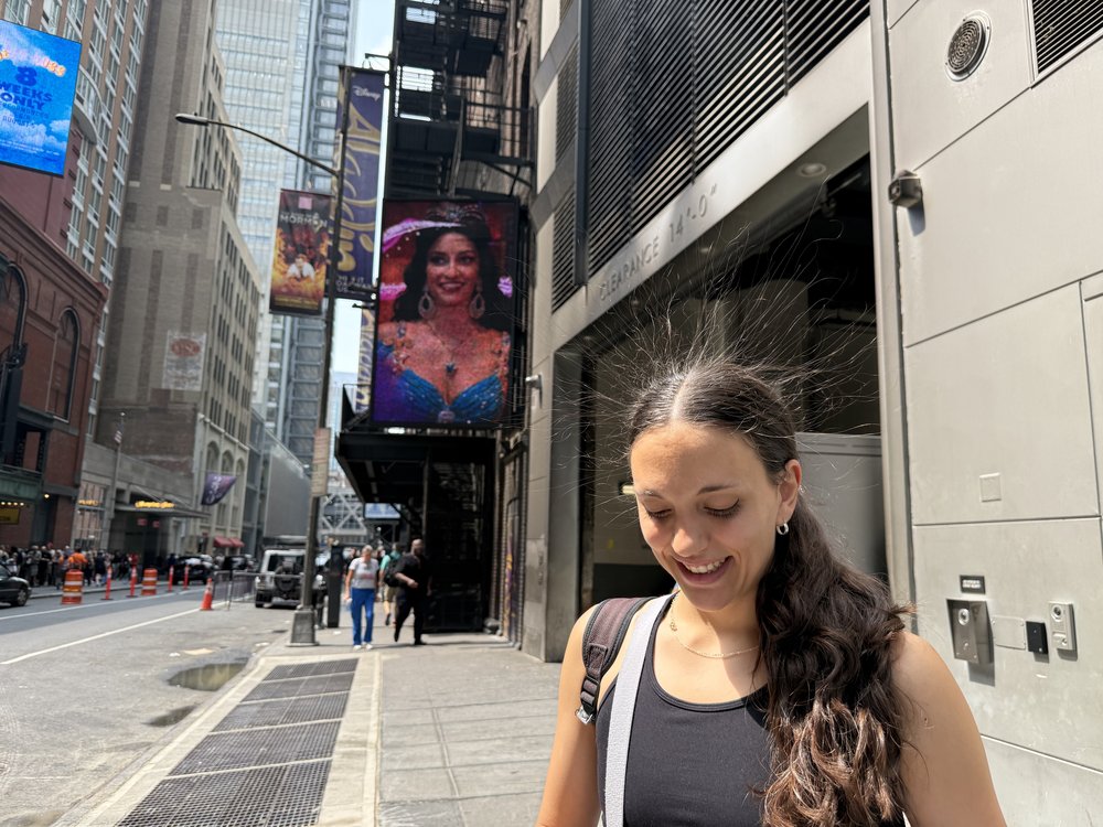 Micaela Folgar, a tourist visiting New York City last week, walks by the intersection of 7th Avenue and 41st Street, and her hair sticks up.