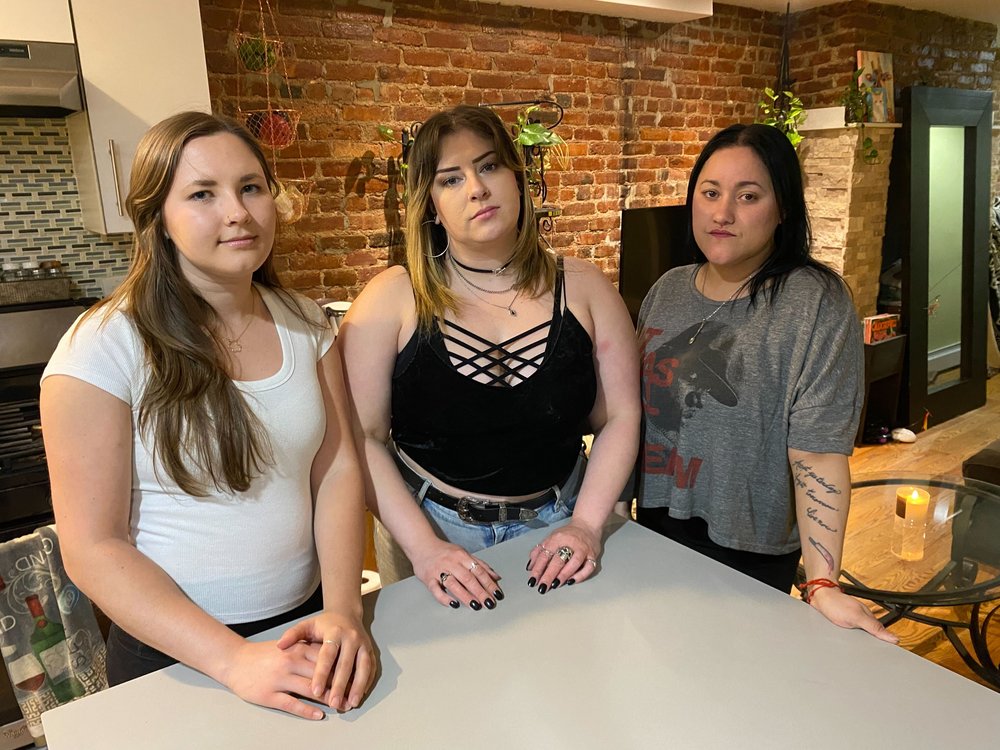 Roommates Allison Lindfors, Ronni Sepesi and Alexa Garcia stand around their kitchen table at their Bushwick apartment.