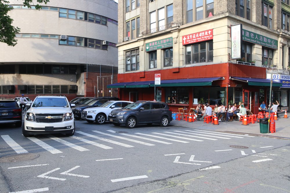 A dead end stretch of a Manhattan city that is used as a parking lot.
