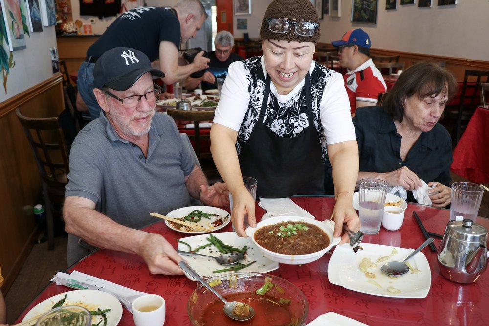 A woman serves lunch at a restaurant.